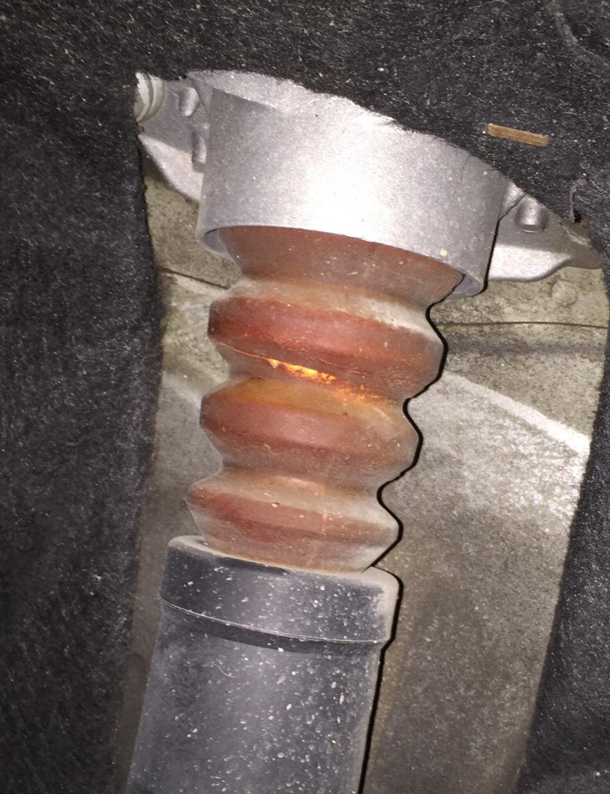 Rubber buffer torn after speedhump....change or not? (With pics)